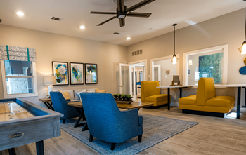 a living room with couches chairs and a table